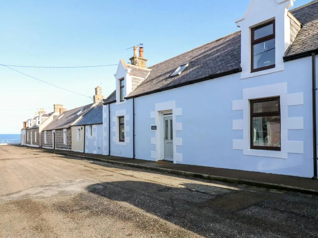 a row of white houses on a street at 4 Gordon Street in Buckie