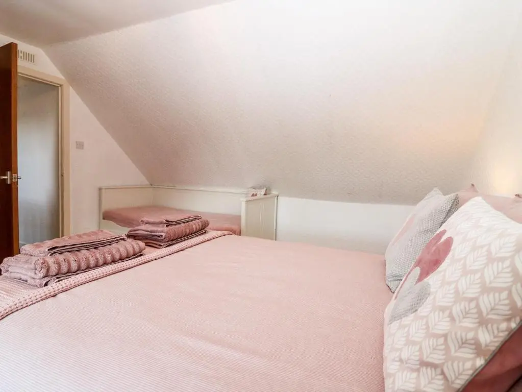 a bedroom with a bed with two pillows on it at 4 Gordon Street in Buckie