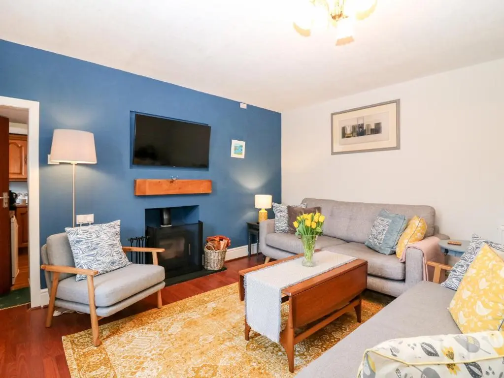 a living room with a couch and a tv at 4 Gordon Street in Buckie