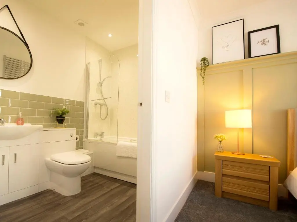 a bathroom with a toilet and a sink at Sandpiper Cottage in Buckie