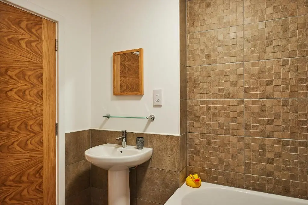 a bathroom with a sink and a toilet and a tub at Aviemore apartment (pet friendly) - sleeps 4 in Aviemore