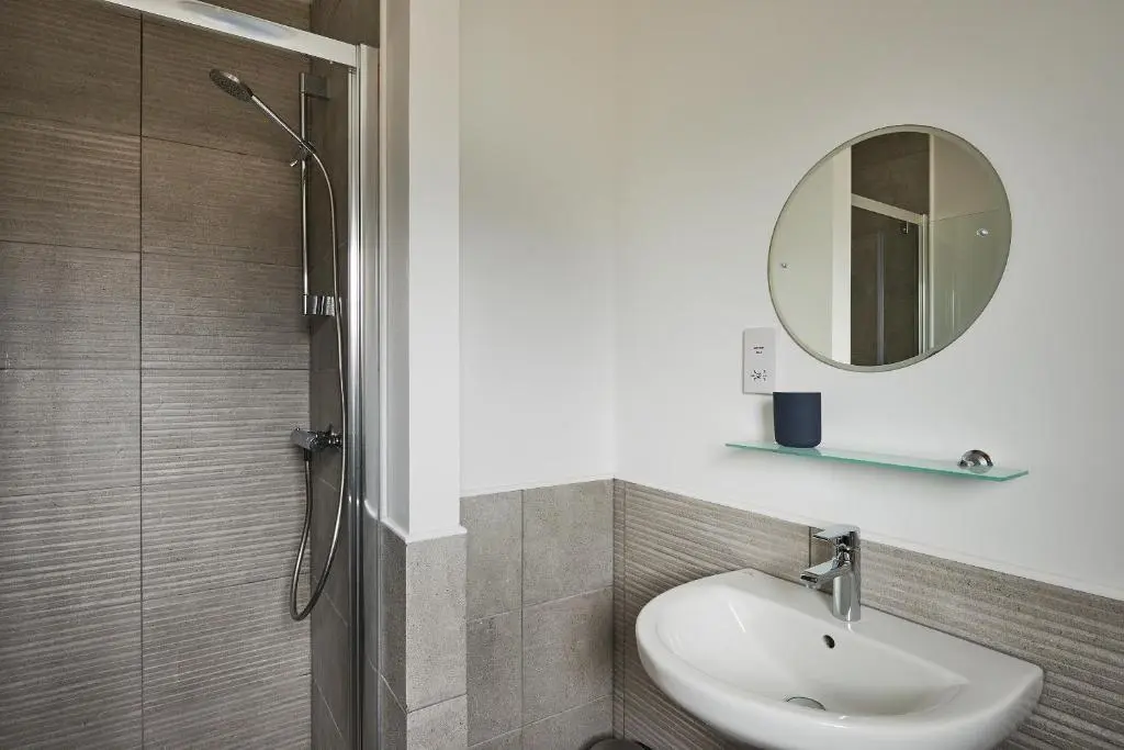 a bathroom with a sink and a mirror at Aviemore apartment (pet friendly) - sleeps 4 in Aviemore