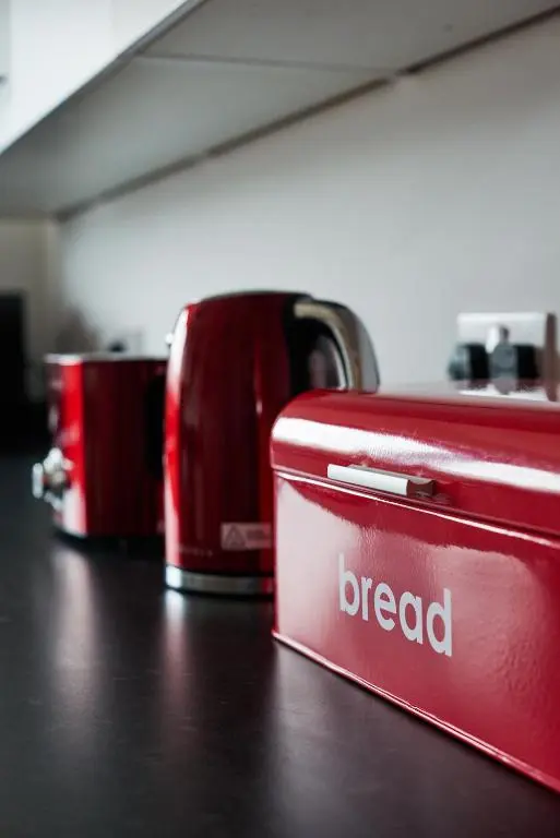 a red briefcase sitting on a table next to a coffee pot at Aviemore apartment (pet friendly) - sleeps 4 in Aviemore