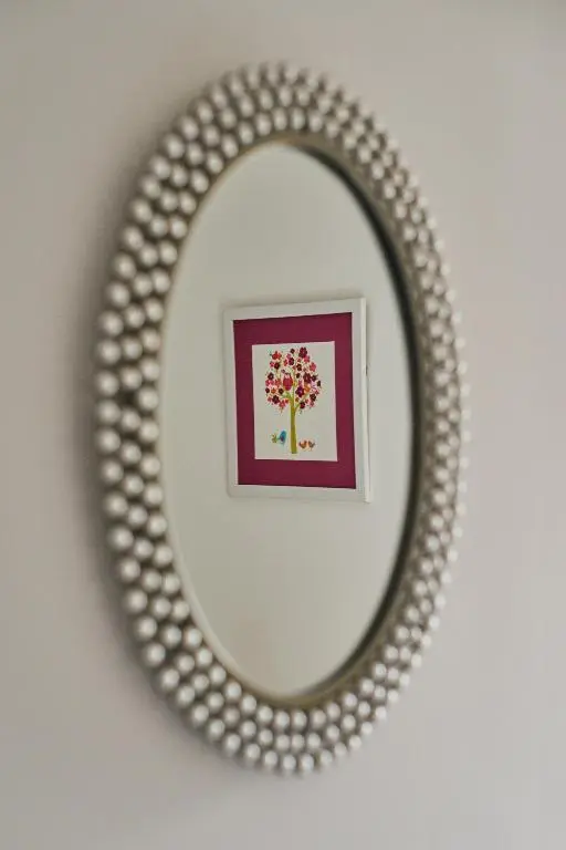 a circular mirror on a wall with a picture at Aviemore apartment (pet friendly) - sleeps 4 in Aviemore