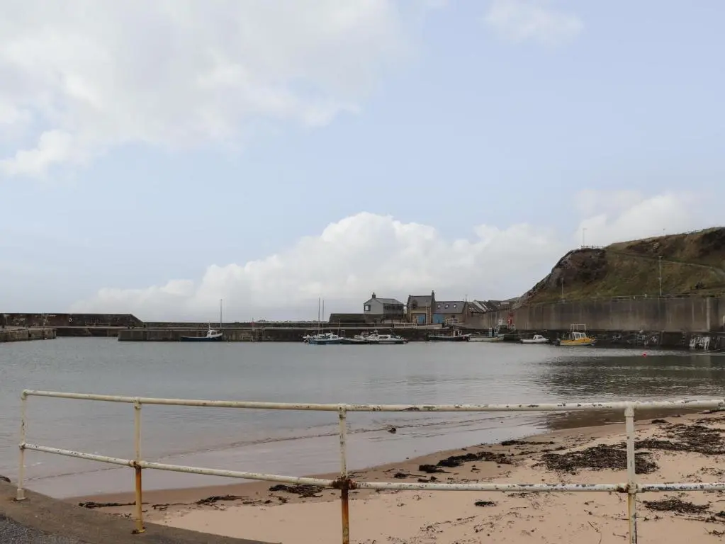 a view of a body of water with boats in it at Eider Cottage in Buckie