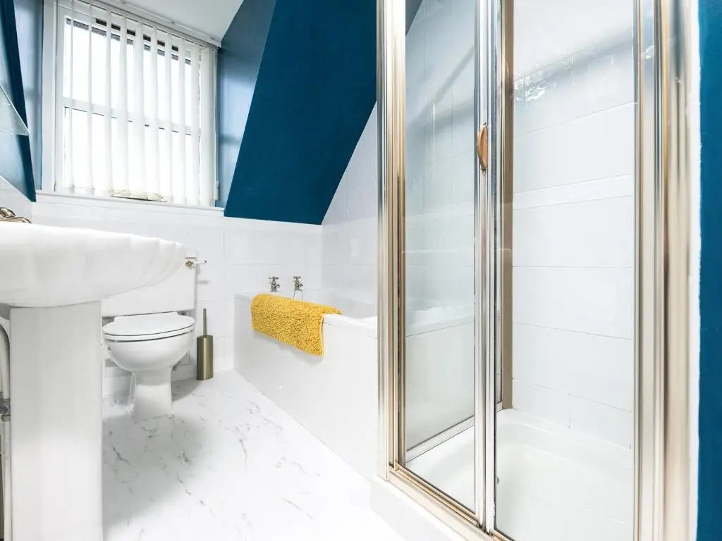 a bathroom with a toilet and a shower at By The Sea in Avoch