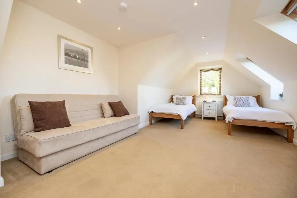 a living room with a couch and a chair at Stunning Country House - Cinema, Games Room & Hot Tub in Inverurie