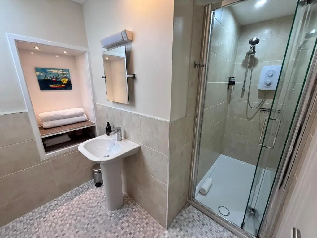 a bathroom with a sink and a shower at The Ullapool Rooms in Ullapool