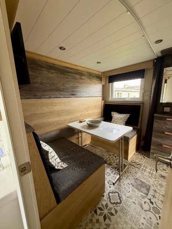 a small room with a table in a trailer at The Willy Gunn Pod - Beautiful, luxury pod in Aberlour