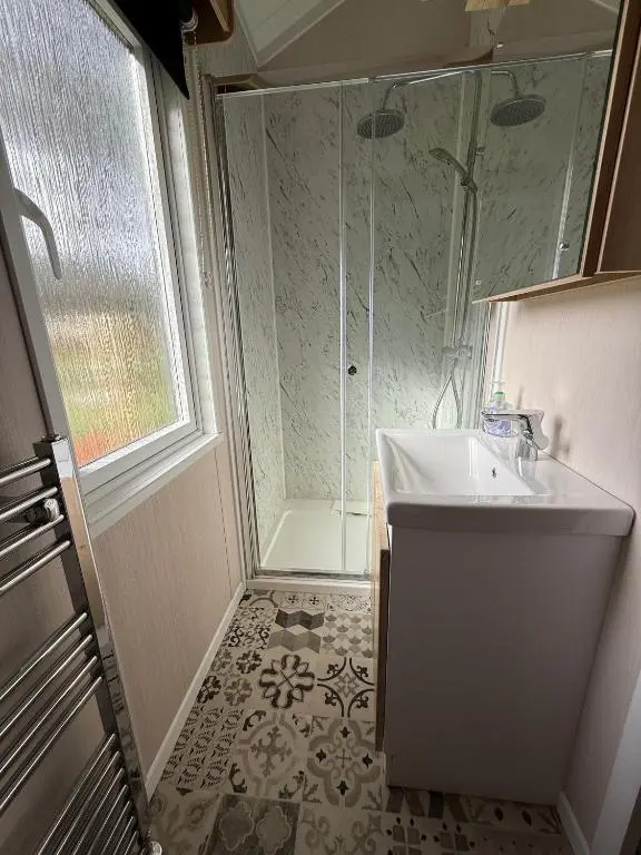 a bathroom with a sink and a shower at The Willy Gunn Pod - Beautiful, luxury pod in Aberlour