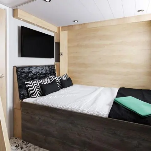 a bedroom with a bed with a wooden head board at The Parr Pod - Beautiful, luxury pod in Aberlour