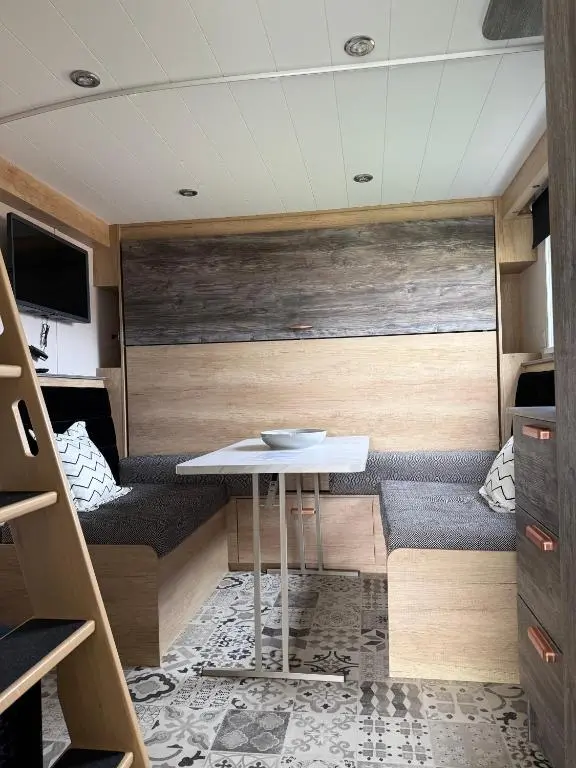 a small room with a table and a couch at The Parr Pod - Beautiful, luxury pod in Aberlour