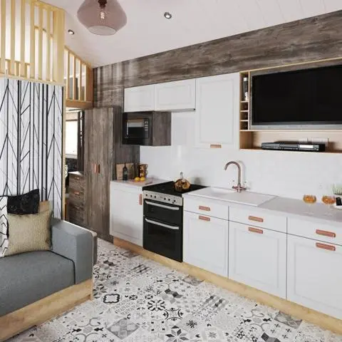 a kitchen with white cabinets and a sink and a couch at The Smolt Pod - Beautiful, luxury pod in Aberlour