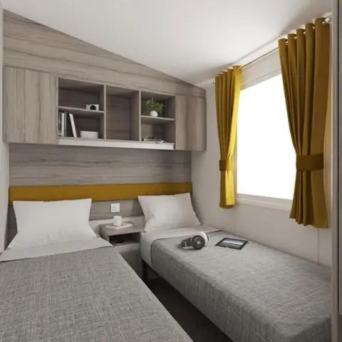a room with two beds and a window at The Salmon Van - Beautiful, luxury static caravan in Aberlour