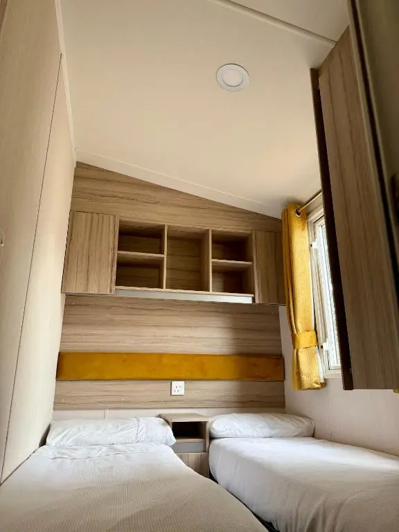 a bedroom with three beds in a room at The Salmon Van - Beautiful, luxury static caravan in Aberlour