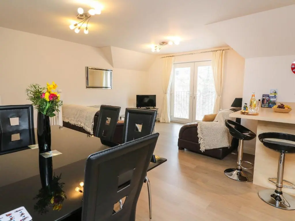 a living room with a bed and a couch at 4 River Court in Invergarry