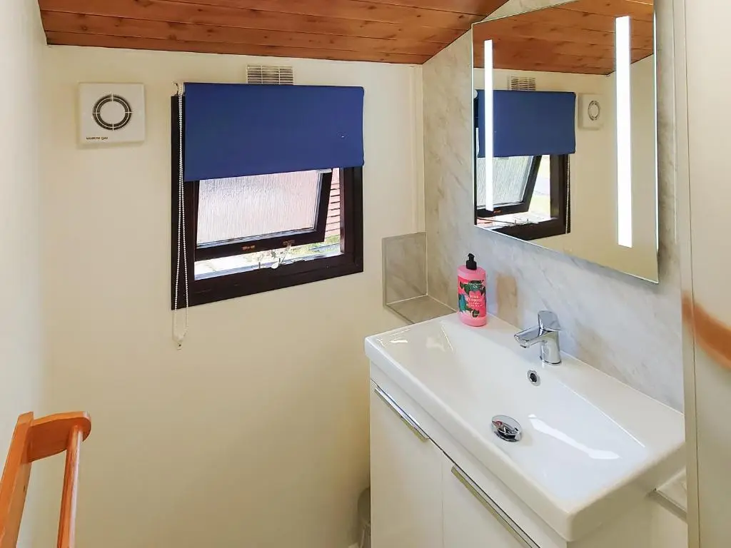 a bathroom with a sink and a mirror at 27 Aviemore Holiday Park in Aviemore