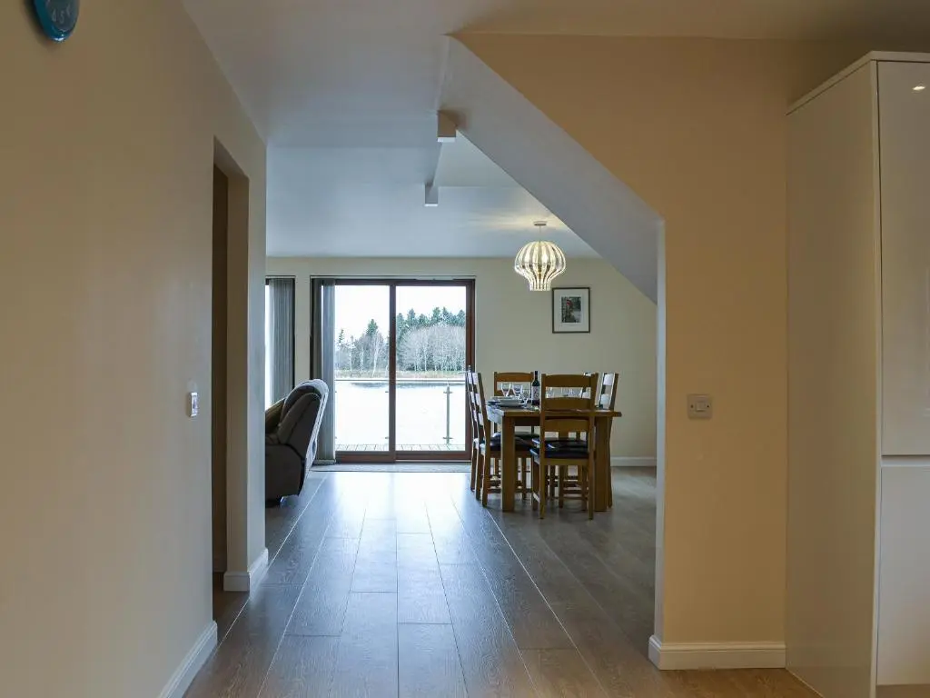 a dining room and living room with a table and chairs at Golf View in Aboyne