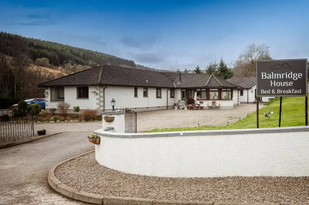 a building with a sign in front of a house at Balmridge House, Loch Ness, Bed & Breakfast in Drumnadrochit