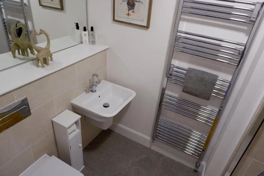 a bathroom with a toilet and a sink and a shower at No 7 Quiet, two bedroom Ground Floor Flat in Tornagrain Great for early Airport departures or late flights in Dalcross