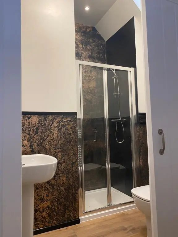 a bathroom with a shower and a sink at Butterfly Cottage in Grantown on Spey