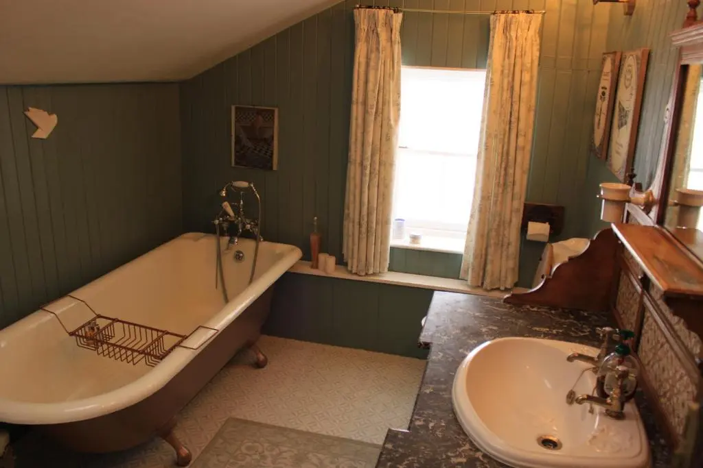 a bathroom with a bath tub and a sink at East Wing Lickleyhead Castle in Auchleven