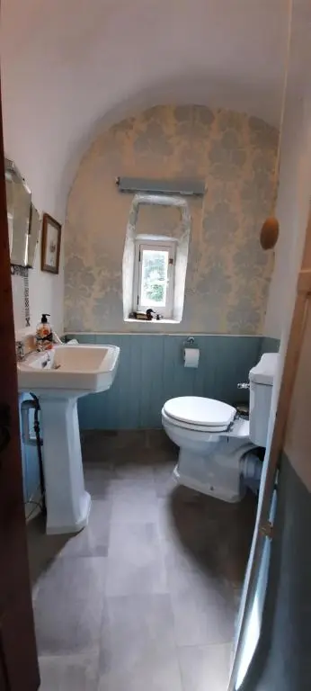 a bathroom with a white toilet and a sink at West Wing Lickleyhead Castle in Auchleven