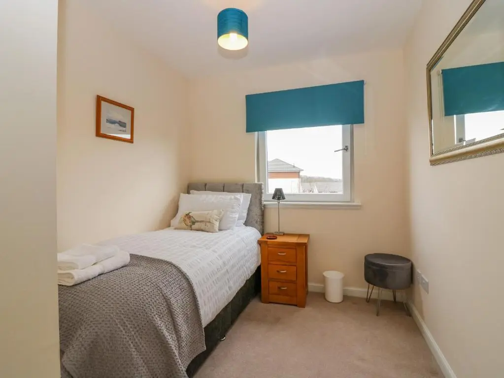 a small bedroom with a bed and a window at 10 Goodhope Gardens in Aberdeen