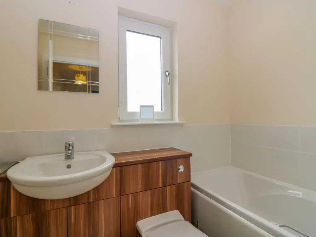 a bathroom with a sink and a toilet and a tub at 10 Goodhope Gardens in Aberdeen