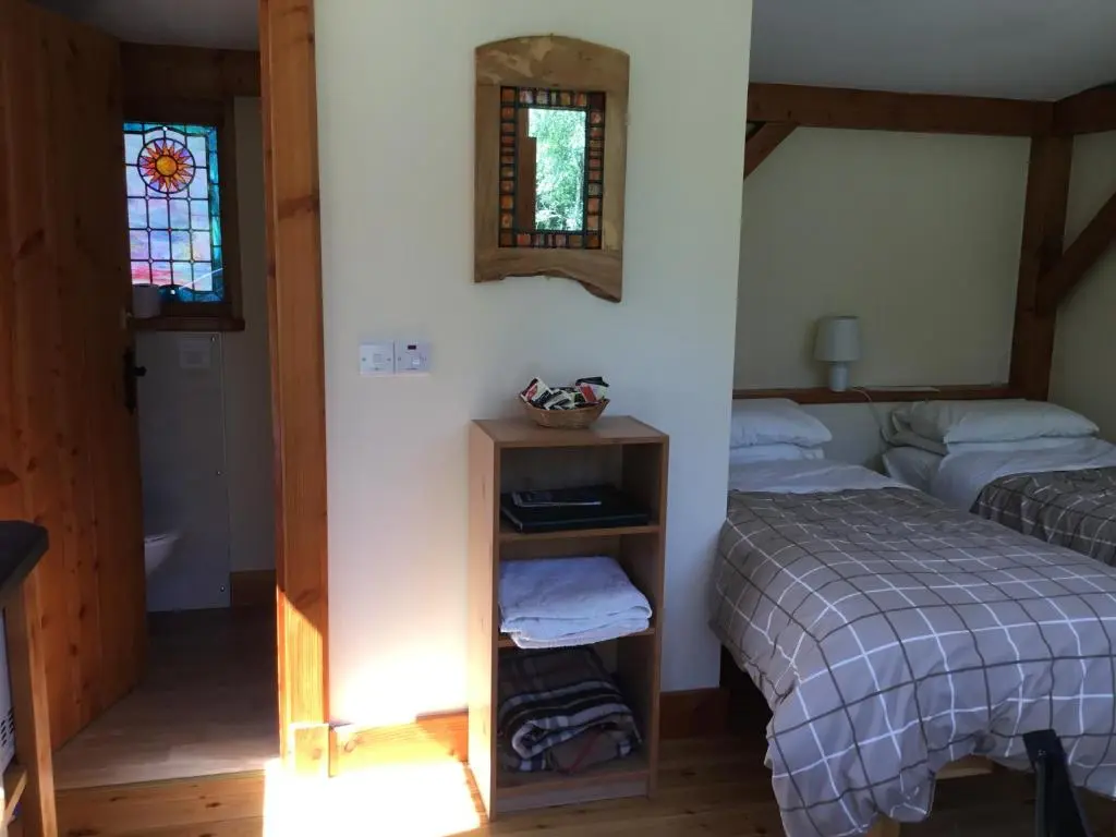 a bedroom with two beds and a window at Caledonian Glamping in Cannich