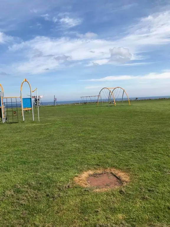 an empty park with an empty playground at Melody Brooks Caravan Park in Portknockie