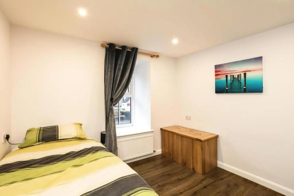 a bedroom with a bed and a window at 29 Seafield Street in Whitehills