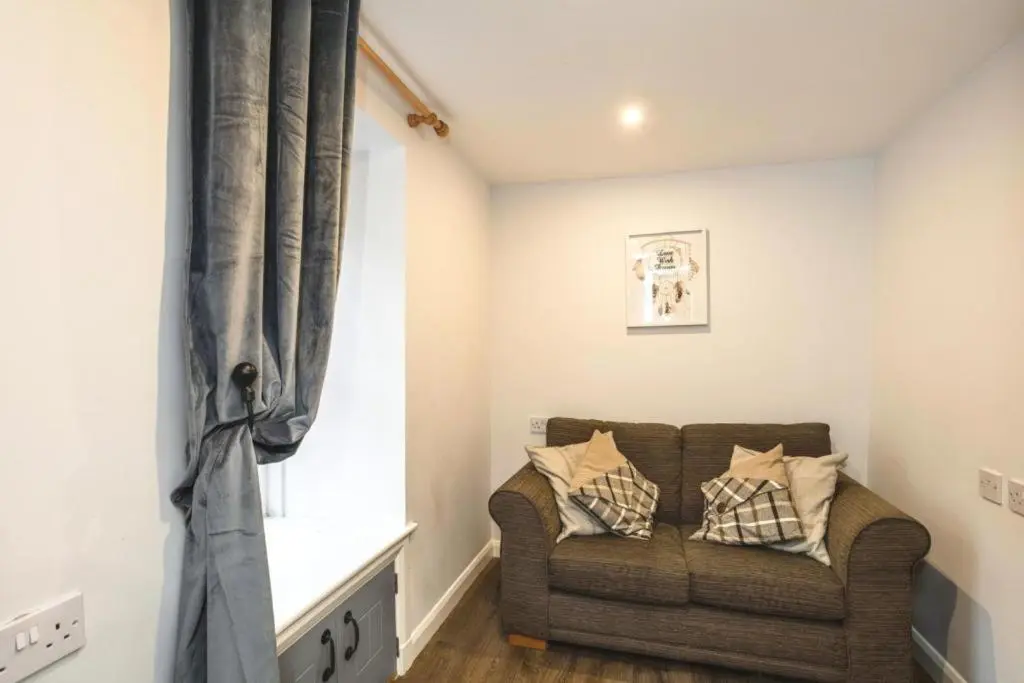 a living room with a couch and a window at 29 Seafield Street in Whitehills
