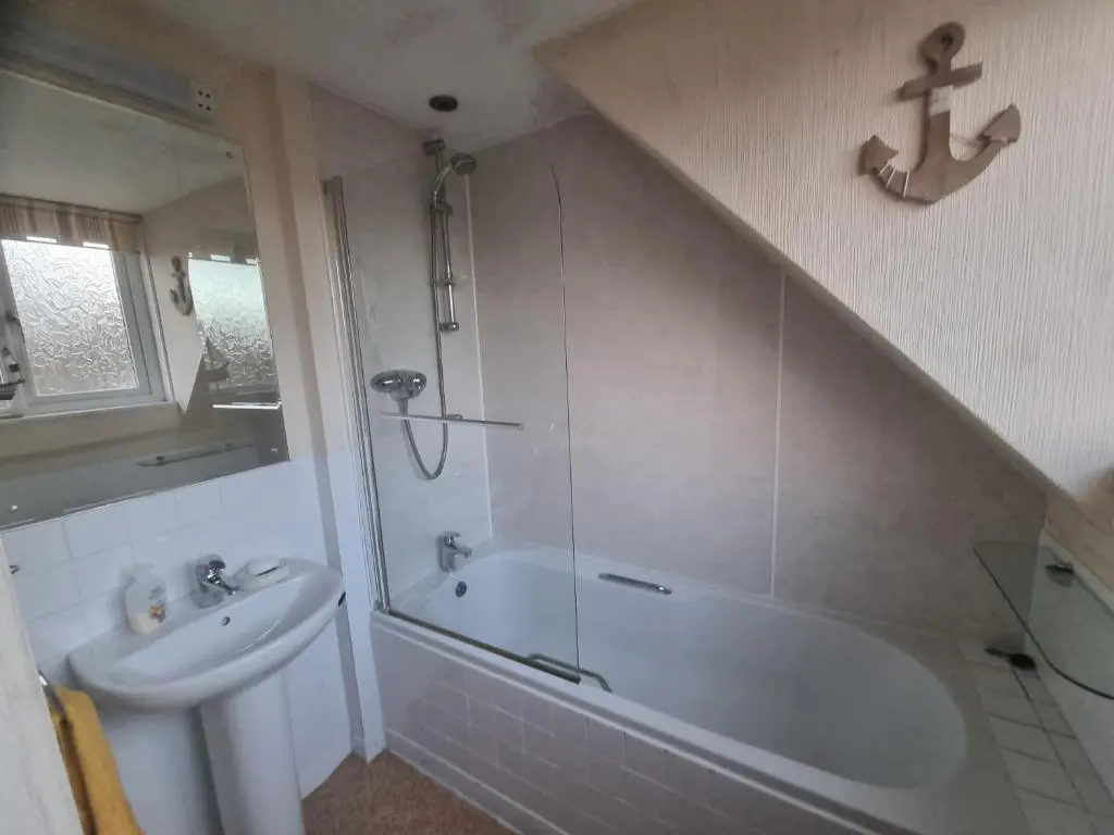 a bathroom with a tub and a sink and a shower at Rose Cottage City Centre in Inverness