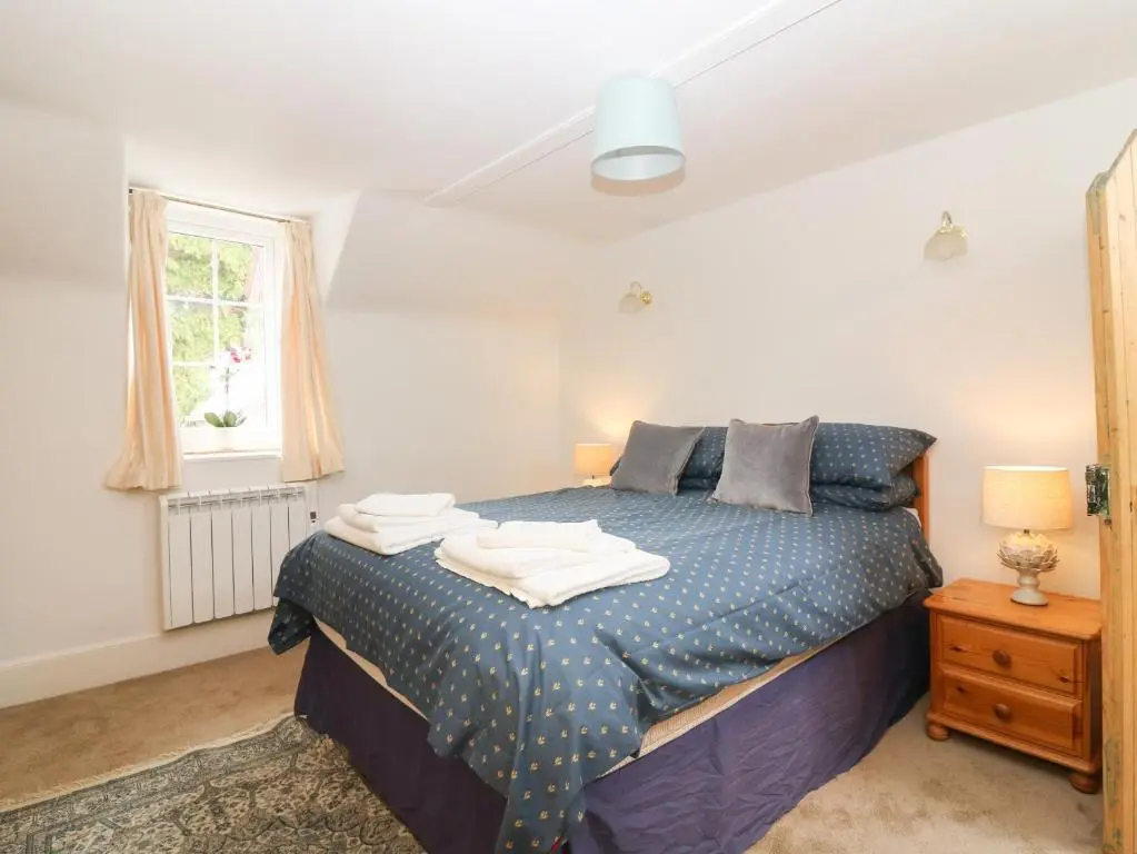 a bedroom with a bed with towels on it at Garden Cottage in Elgin