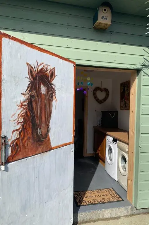 a painting of a horse on the side of a house at The Stable - NC500 in Wick