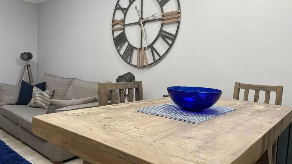 a wooden table with a blue bowl on top of it at The Store by Caithness Luxury Apartments NC500 - Luxury modern conversion with open plan living - Sleeps 4 in Wick