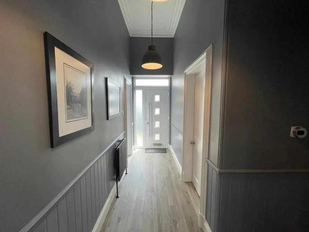 a hallway of a home with gray walls and wooden floors at The Store by Caithness Luxury Apartments NC500 - Luxury modern conversion with open plan living - Sleeps 4 in Wick