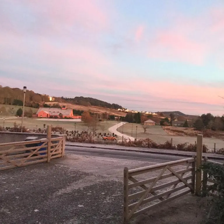 a wooden fence on the side of a road at Charleston Apartment Self Catering 5 min drive from town centre in Inverness