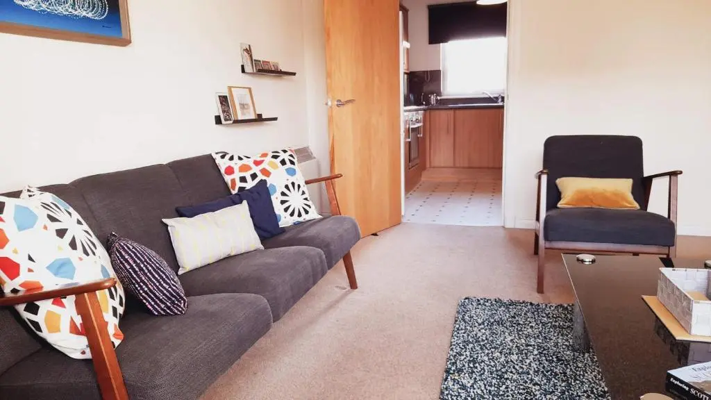 a living room with a couch and a chair at Beauly Holiday Home in Beauly