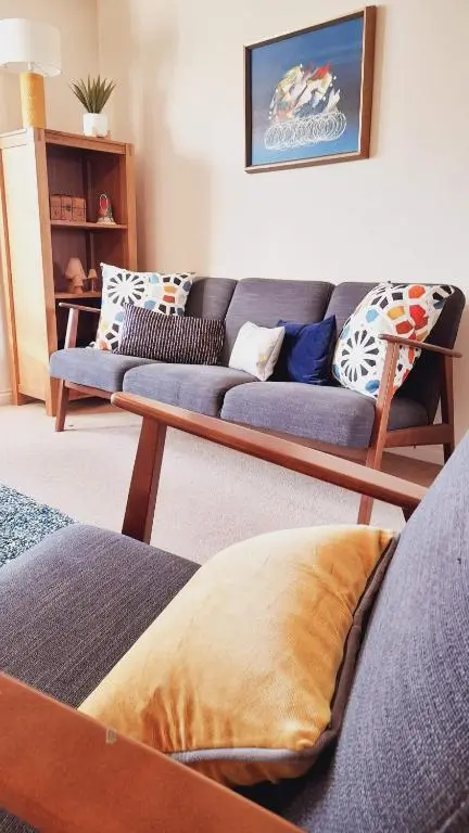 a living room with two blue couches at Beauly Holiday Home in Beauly