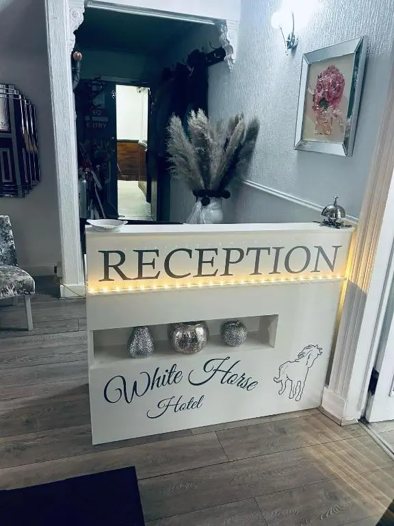 a white staircase with a sign that reads regeneration white hair field at White Horse Hotel in Strichen