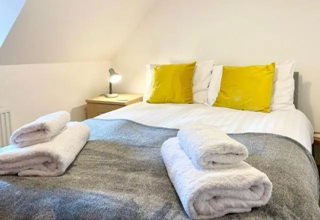 a bedroom with a bed with towels on it at The Smiddy in Inverness