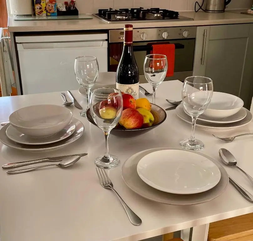 a table with wine glasses and a plate of fruit at The Smiddy in Inverness