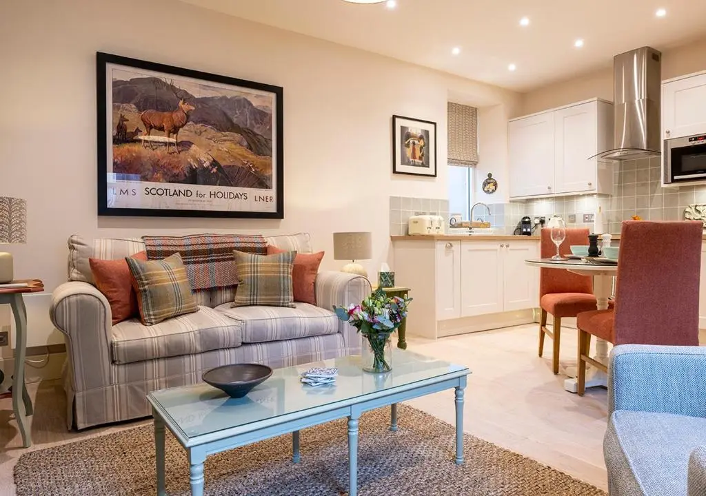 a living room with a couch and a table at The Hideaway in Inverness