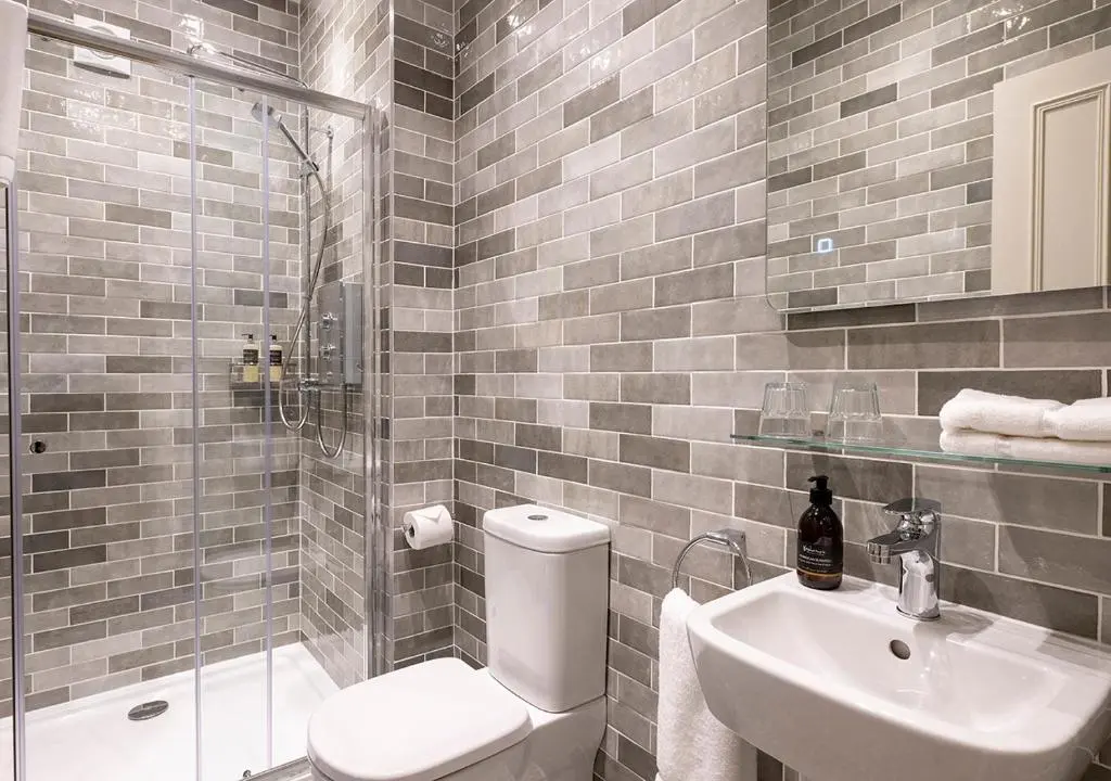 a bathroom with a toilet and a sink and a shower at The Hideaway in Inverness