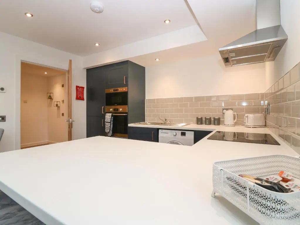 a kitchen with a white counter top in a room at The Dance Hall, The Institute Executive Apartments in Keith
