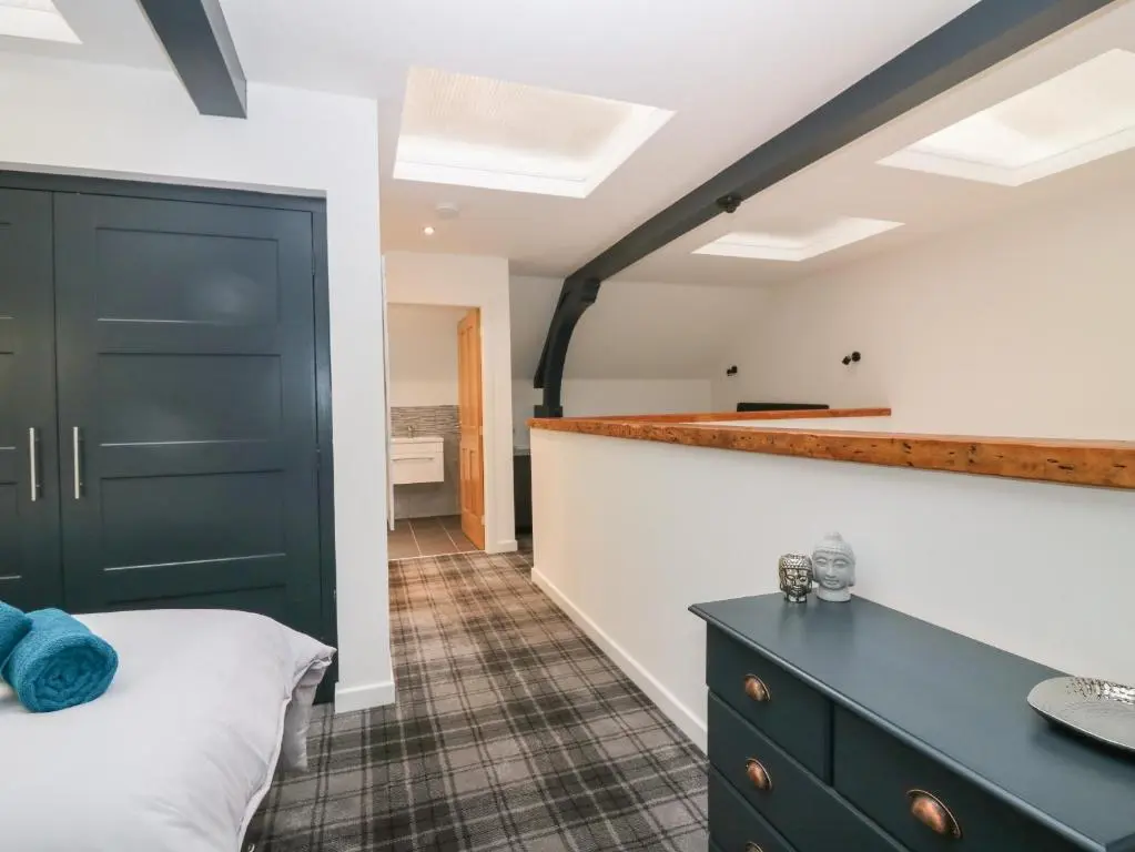 a bedroom with a black door and a black dresser at The Dance Hall, The Institute Executive Apartments in Keith