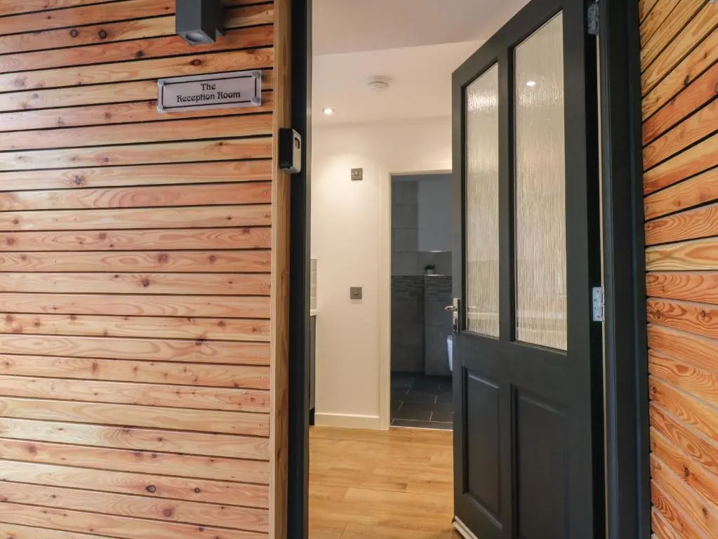 a door to a room with a wooden wall at The Reception Room at The Institute Executive Apartments in Keith