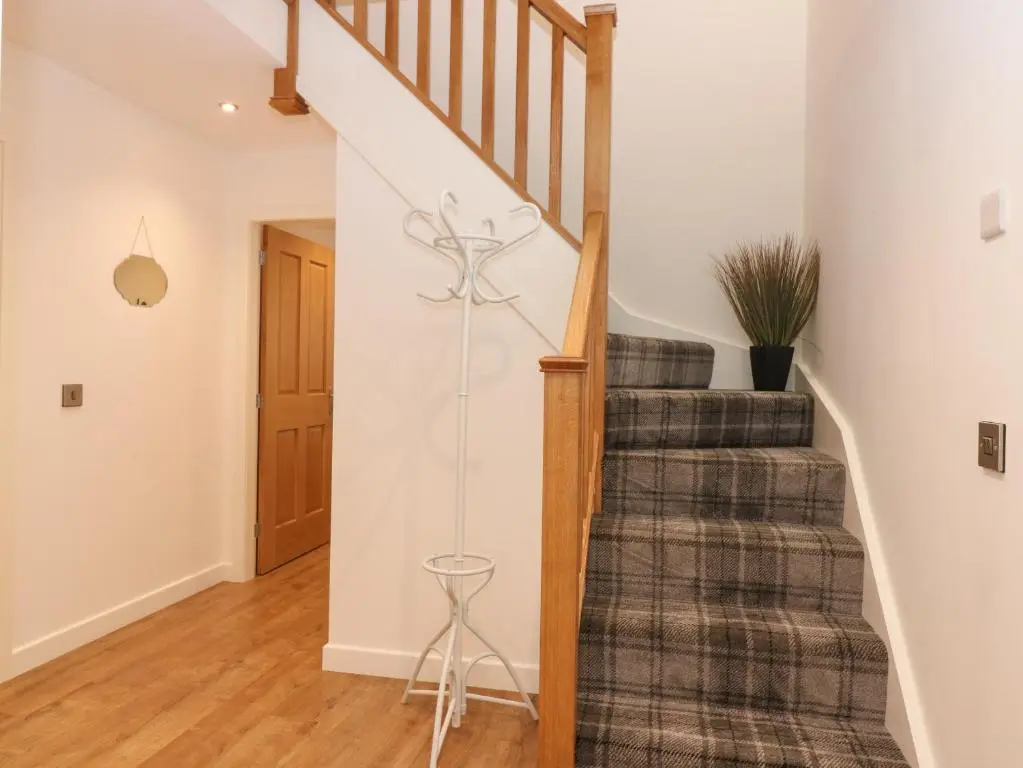 a staircase in a home with a rug at The Reception Room at The Institute Executive Apartments in Keith